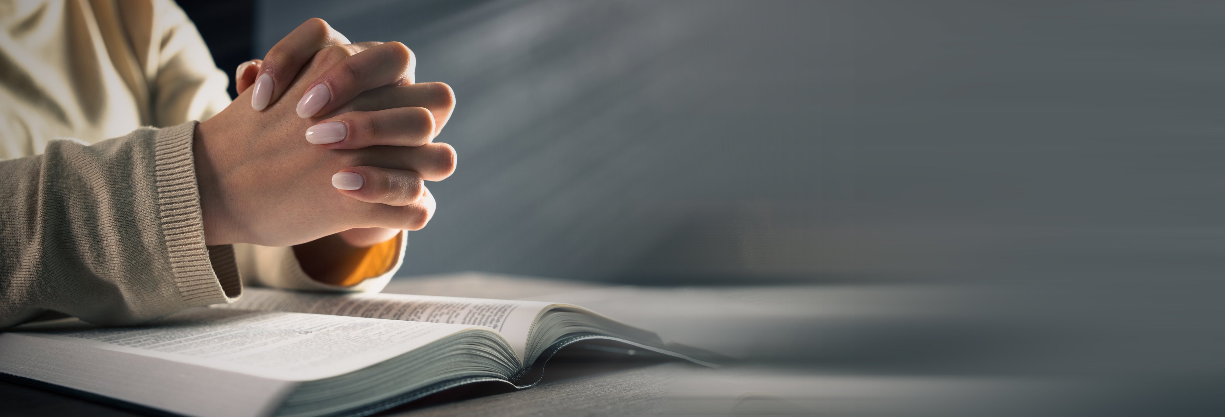 Woman praying on bible